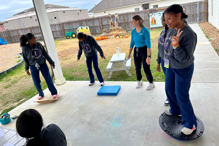 Pediatric Therapy Solutions physical therapists conducting outdoor balance training.